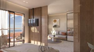 a bedroom with a bed and a view of the ocean at Kakkos Terra Blu Hotel in Ierapetra
