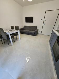 a living room with a couch and a table at Sabotino suite in Avezzano