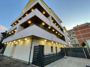a large white building with lights on it at Sabotino suite in Avezzano