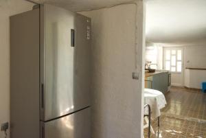 a kitchen with a stainless steel refrigerator in a room at Robinson Ilijana in Gdinj