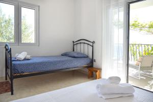 a bedroom with a bed and a balcony at Robinson Ilijana in Gdinj