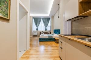 a kitchen and a bedroom with a bed in a room at Palm Beachfront Suites by PS in Durrës