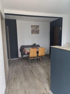 a dining room with a table and two chairs at Cozy House Corbu in Corbu +3 photos