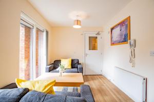 a living room with a couch and a table at Central Limerick Bright & Spacious Apartment in Limerick