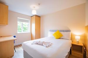 a bedroom with a large white bed and a window at Central Limerick Bright & Spacious Apartment in Limerick