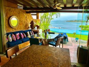 a dining room with a table and a view of the ocean at 1 bdrm condo, Manzanillo Bay, Troncones in Troncones