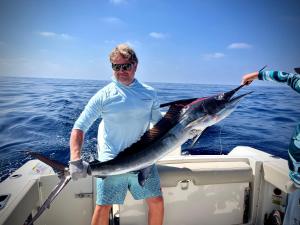 a man holding a fish on a boat at 1 bdrm condo, Manzanillo Bay, Troncones in Troncones