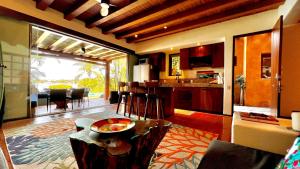 a kitchen and living room with a table and chairs at 1 bdrm condo, Manzanillo Bay, Troncones in Troncones
