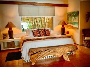 a bedroom with a bed with a large window at 1 bdrm condo, Manzanillo Bay, Troncones in Troncones +21 photos