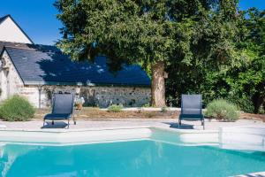 two chairs sitting next to a swimming pool at La Boire Bavard in Blaison