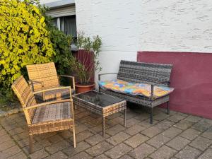 two chairs and a bench with a pillow on it at Ferienwohnung Carl in Weikersheim