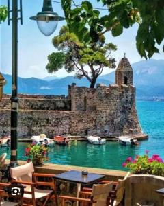 a castle in the water with boats in it at RRooms in Nafpaktos