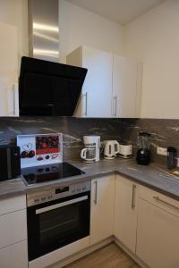 a kitchen with a stove and a counter top at Ingrid in Schwarzatal