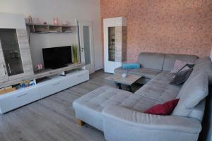 a living room with a couch and a television at Ingrid in Schwarzatal