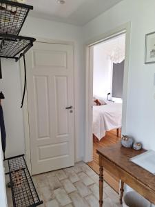 a white door in a room with a bedroom at Guesthouse in Gustavsberg