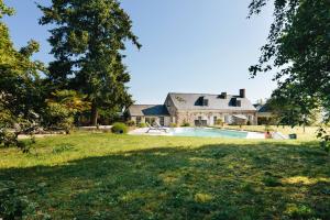 an estate with a swimming pool in front of a house at La Boire Bavard in Blaison