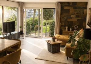a living room with a couch and a table at Erftlodges L2 in Bad Münstereifel