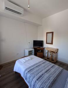 a bedroom with a bed and a table with a mirror at Affitta camere Via Piave in Foligno