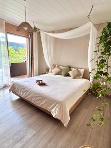 a bedroom with a large bed with a canopy at Lake View Balcony in Le Chenit