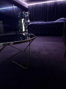 a living room with a couch and a glass table at Moonlight jacuzzi in Stargard