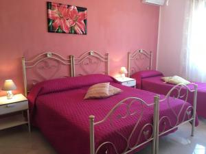 Łóżko lub łóżka w pokoju w obiekcie B&B Villa Giacrì