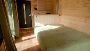 a small bed in a room with a window at Aurakoski 1 in Ranua