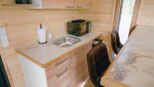 a tiny kitchen with a sink and a microwave at Aurakoski 1 in Ranua