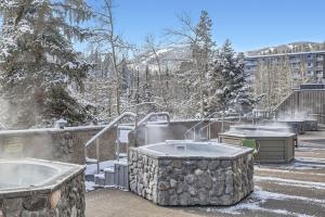 a couple of hot tubs in a yard with snow at Beaver Run 1 Bedroom Condo in Breckenridge