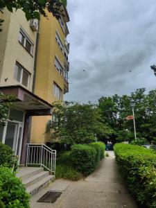 a yellow building with a staircase next to a street at Cozy apartment in Bitola in Bitola