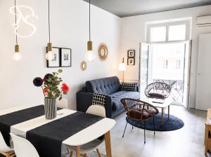 a living room with a blue couch and a table at Cannes - Modern balcony flat perfect location in Cannes