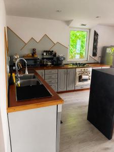 a kitchen with a sink and a counter top at Kurna Chata in Żyłka +67 photos
