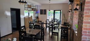 a restaurant with tables and chairs and a brick wall at Turystyczna 9 apartamenty & cafe in Sobótka