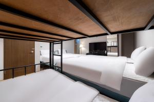 a bedroom with two beds and a television at Soosong Guesthouse Gwanghwamun Myeongdon g in Seoul