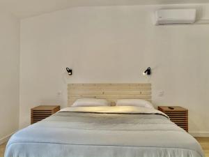 a bedroom with a large bed with two night stands at Camping 4 étoiles - Piscine - ccbgbac in Arques