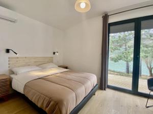 a bedroom with a bed and a large window at Camping 4 étoiles - Piscine - ccbgbac in Arques
