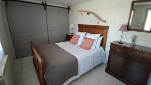 a bedroom with a bed with white sheets and pink pillows at Les Terrasses d'Antonin in Grambois +38 photos