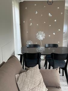 a living room with a couch and a table with chairs at Villa Paradiso in Loosdrecht