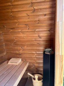 a room with a wooden wall with a bench and a toilet at Villa Paradiso in Loosdrecht +57 photos