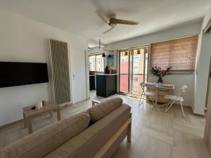 a living room with a couch and a table at Chez Raka in Hyères