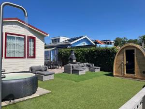 a backyard with a hot tub and a gazebo at Villa Paradiso in Loosdrecht