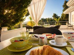 a table with plates of food and a cup of coffee at Petra Maris B&B in Peschici