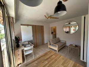 a living room with a couch and a table at Chez Raka in Hyères +8 photos