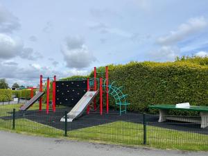 a playground in a park with a slide at Villa Paradiso in Loosdrecht