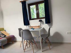 a table and chairs in a room with a window at Kalithea Palekastro in Palekastron