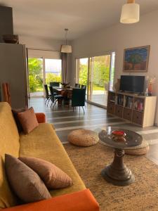 a living room with a couch and a table at Villa Elpiniki in Ixia