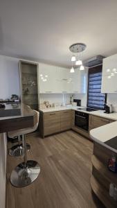 a large kitchen with wooden floors and white cabinets at Belgrade River House in Belgrade