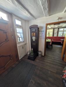 a room with a hallway with a door and a living room at Westfalenkrug in Wuppertal +18 photos