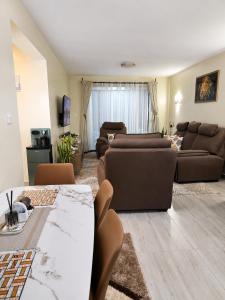 a living room with a couch and a table at Savanna Living in Nakuru
