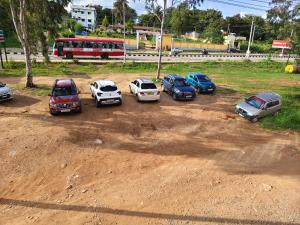 a group of cars parked in a parking lot at Hotel Relax inn in Chikmagalūr