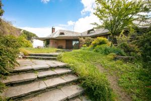 a house with stone steps in front of it at Villa Inella in Oggiono